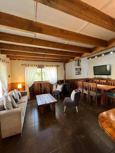 a living room with a couch and a table at Cabañas Alto Bosque in Pucón