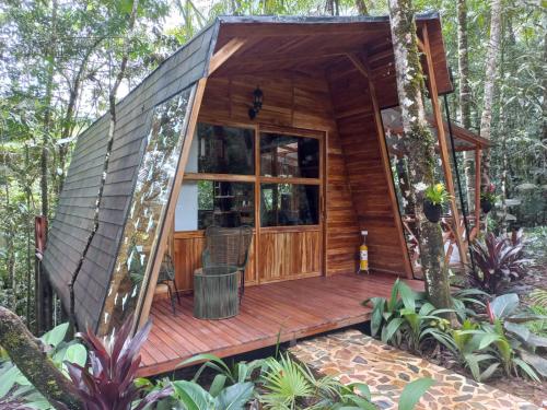 a cabin in the woods with a wooden deck at ECO HOTEL RIO DE ORO in San Rafael