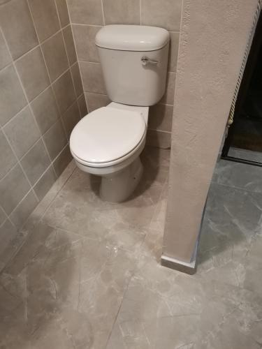 a bathroom with a white toilet in a stall at Dreamers nest in Richards Bay