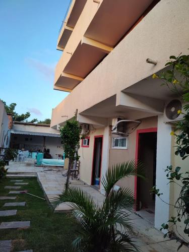 an outside view of a building with a pool at Pousada paraiso das dunas in Cumbuco