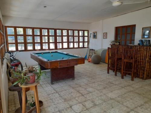 a living room with a pool table in it at Popoyo Surfcamp in Popoyo