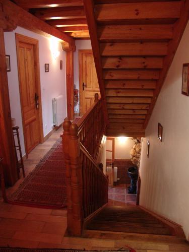 a hallway with a staircase with a wooden ceiling at Hotel Rural La Puebla in Orbaneja del Castillo