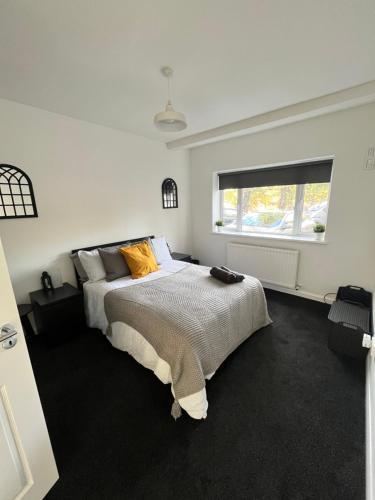 a bedroom with a large bed and a window at Castle Court Apartment in London