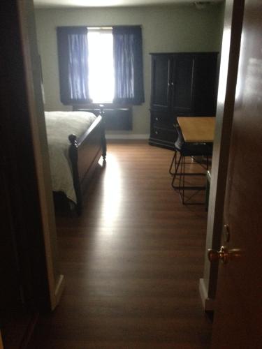 a bedroom with a bed and a desk and a window at Chaffee Lodge in Chaffee