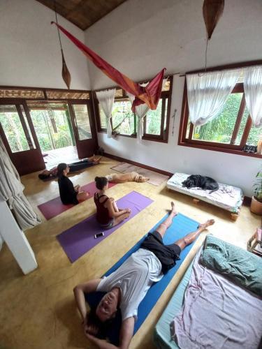 a group of people doing yoga in a room at Sitio Namaste in Itacaré