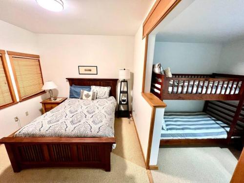 a bedroom with two bunk beds and a staircase at Ski In/Ski Out Luxury Home w/ jacuz/ fireplace in Whistler