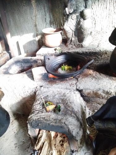 a stone oven with food inside of it at Shanti Natural Panorama View Hotel in Singaraja