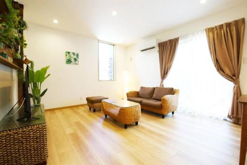 a living room with a couch and a table at Bunzo Rezort 今帰仁 in Shushi