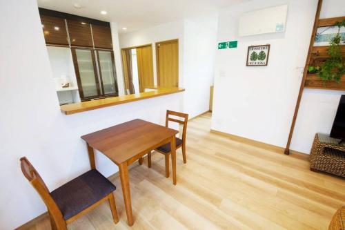 a dining room with a table and two chairs at Bunzo Rezort 今帰仁 in Shushi
