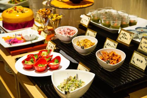 a buffet with various dishes of food on a table at Akarinoyado Togetsu in Beppu