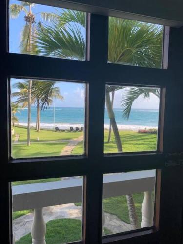 a window view of the beach from a house at Cabarete Beachfront Condos Nanny Estate A3 in Cabarete