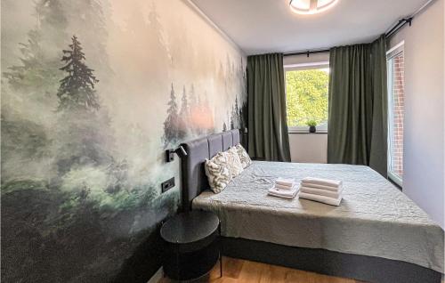 a bedroom with a bed and a painting on the wall at 1 Bedroom Stunning Apartment In Gdansk in Gdańsk
