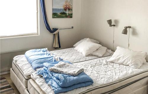 two beds with pillows on them in a bedroom at 3 Bedroom Cozy Home In Svanesund in Svanesund
