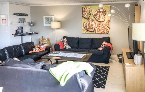 a living room with two couches and a table at 3 Bedroom Cozy Home In Svanesund in Svanesund