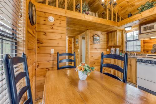 a dining room with a wooden table and chairs at The Homeplace in Sevierville