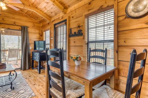 a dining room with a wooden table and a desk at The Homeplace in Sevierville