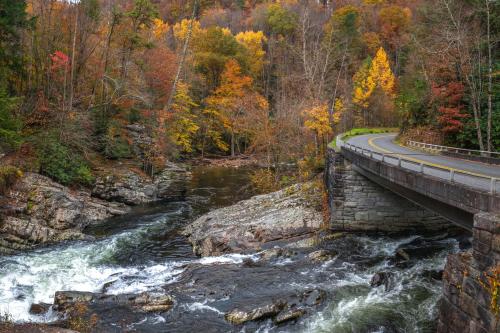 a bridge over a river next to a road at The Homeplace in Sevierville