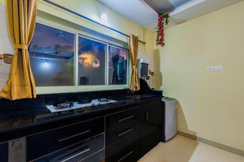 a bathroom with a sink and a window at 4bhk Stunning Apartment with Pool 2bhkX2 in Old Goa