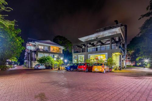 a parking lot with cars parked in front of buildings at 4bhk Stunning Apartment with Pool 2bhkX2 in Old Goa