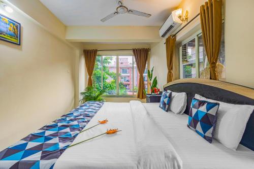 a large bed in a room with a window at 4bhk Stunning Apartment with Pool 2bhkX2 in Old Goa