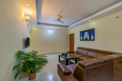 a living room with a couch and a table at 4bhk Stunning Apartment with Pool 2bhkX2 in Old Goa