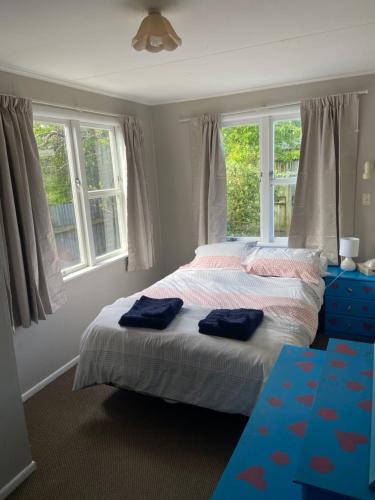 a bedroom with a bed with two blue towels on it at 3-bedroom unit within walking distance to city in Hamilton