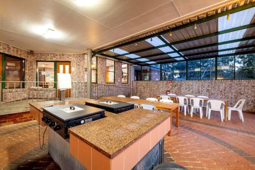 a large room with tables and chairs in a building at BIG4 Mudgee Holiday Park in Mudgee