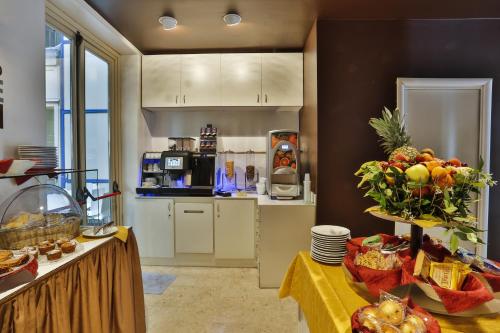 a kitchen with a table with food on it at Hotel & Residence Torino Centro - Stazione Porta Susa in Turin