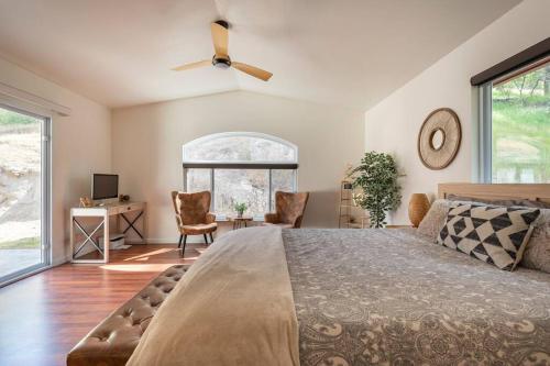 a bedroom with a large bed with a ceiling fan at Villa near Yosemite & bass lake w/Hot Tub/EVcharge in Oakhurst