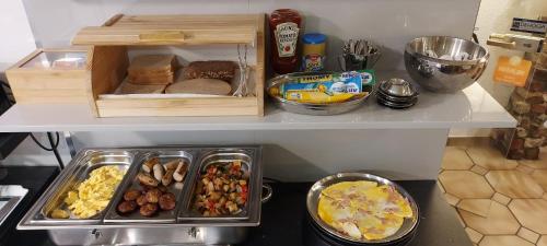 a refrigerator filled with lots of different types of food at Hotel Müller Köln in Cologne