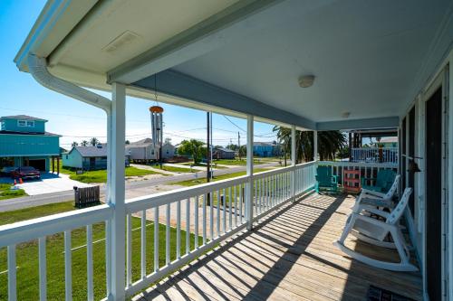 a porch with two chairs and a view of a street at Lunasea Haven in Rockport
