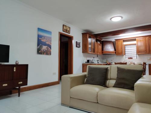 a living room with a couch and a kitchen at In the Heart of Bugibba in St. Paul's Bay