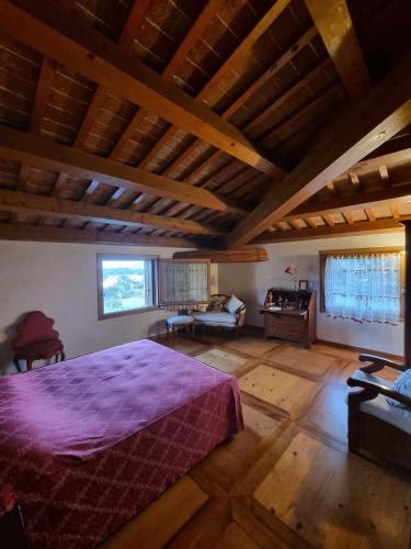 a bedroom with a large bed in a room with wooden floors at Villa Valmarana De Toni in Creazzo