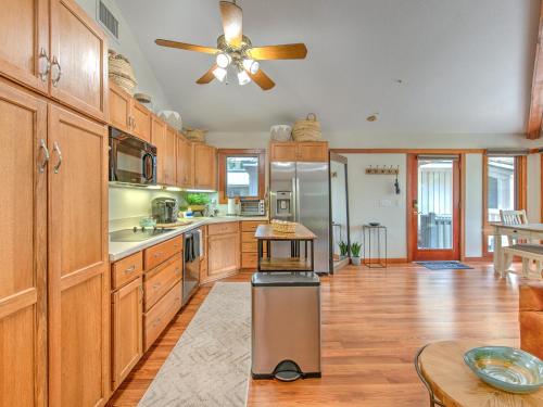 a kitchen with wooden cabinets and a ceiling fan at Riverbend Retreat Fla in Riverview