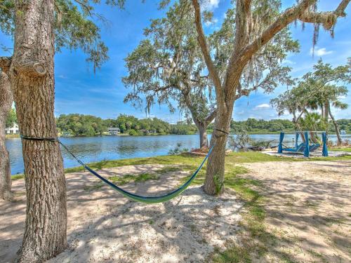 a hammock hanging between two trees next to a lake at Riverbend Retreat Fla in Riverview