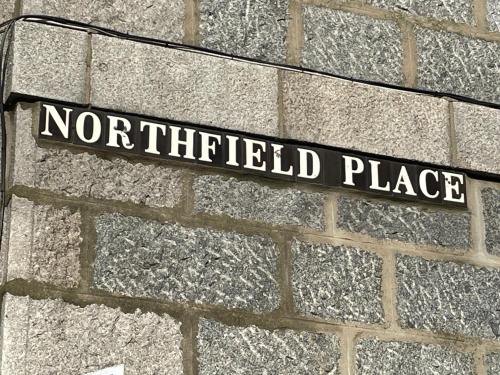a street sign on the side of a brick wall at Amazing Getaways - The Place for You with Free Parking in Aberdeen