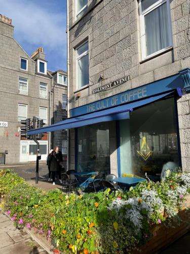a restaurant with a blue awning on a building at Amazing Getaways - The Place for You with Free Parking in Aberdeen