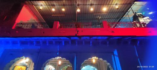 a room with a red and blue lights on a ship at Hotel Bharatpur Palace in Pushkar