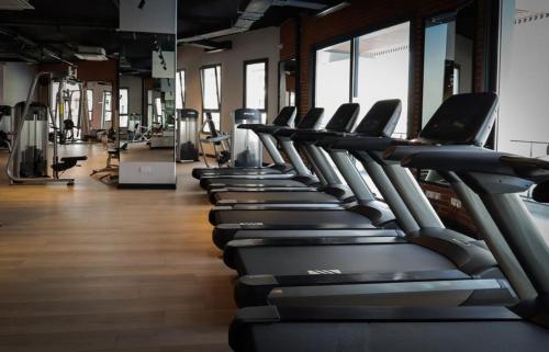 a row of cardio machines in a gym at Sophia Pool Apartments in Caesar Blue Resort, Fixed Lunch till 3pm, Gym, Swimming Pools, Sauna, Hammam, Kids' club available in Perivolia tou Trikomou