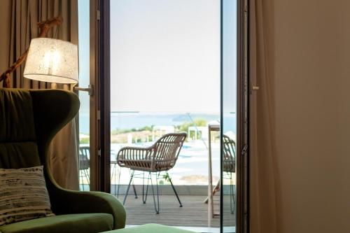 a room with a sliding glass door leading to a patio at WHITE DONKEY BOUTIQUE Hotel in Chrani