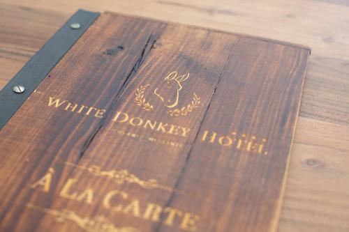 a wooden table with a book on top of it at WHITE DONKEY BOUTIQUE Hotel in Chrani