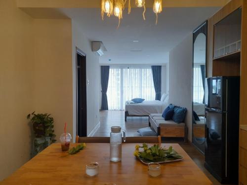 a kitchen and living room with a table with a plate of food at Happy Home in Nha Trang