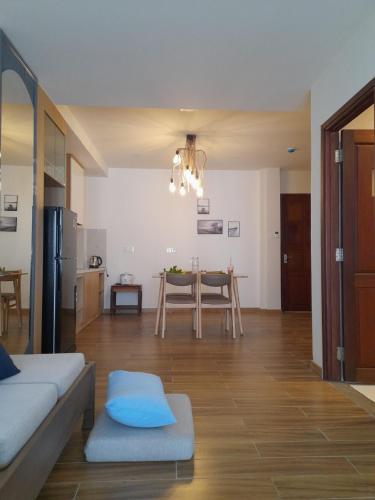 a living room with a table and a dining room at Happy Home in Nha Trang