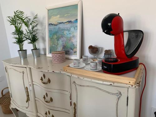 a red appliance sitting on top of a dresser at Despertar in Antequera