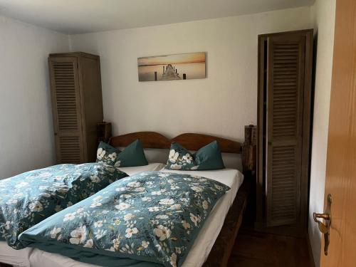 a bedroom with two beds with blue and white pillows at Richtberg 2 in Plau am See