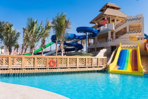 a resort with a slide and a water park at Hawana Salalah Laguna Studio in Salalah