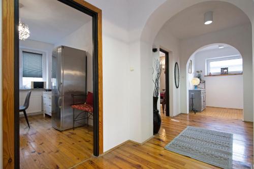 a mirror in a living room with a refrigerator at Apartament na Fatimskiej in Kraków