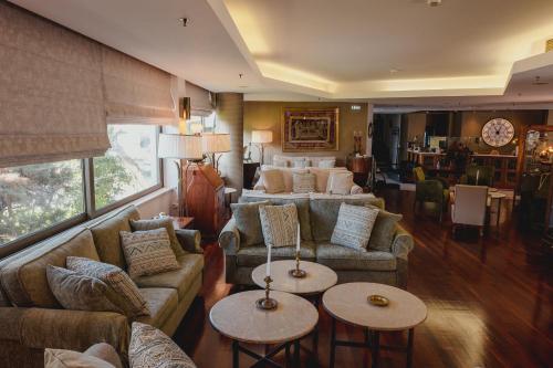 a living room with two couches and two tables at Mati Hotel in Mati
