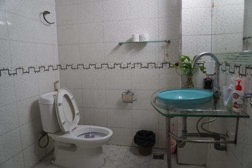 a bathroom with a toilet and a sink at Green Riders House in Cao Bằng