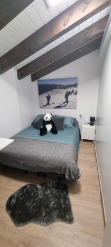 a bedroom with a bed with a panda bear on it at APART-SKY A PIE DE PISTAS PARA 6PERSONAS - LA MOLINA ESTACIÓN in La Molina